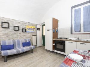a living room with a couch and a kitchen at Holiday Home Kicca by Interhome in Sanremo