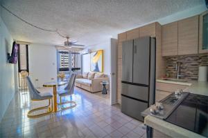 a kitchen and living room with a table and chairs at Budget-Friendly Haven- Comfort & Convenience in San Juan