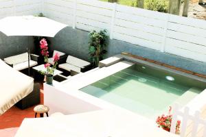 a small swimming pool on top of a patio at Villa Kouros in Melíssia