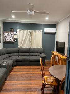 a living room with a couch and a table at Central on Shenton in Geraldton