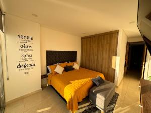 a bedroom with a bed and a sign on the wall at Departamento a pie de playa en Camino al Mar in Mazatlán