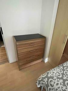 a bedroom with a dresser and a bed in a room at Great for Families/Work/Medical - 2Br Condo A/C in San Rafael
