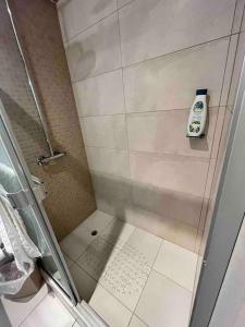 a shower with a glass door in a bathroom at Great for Families/Work/Medical - 2Br Condo A/C in San Rafael