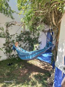 a blue hammock hanging from a tree next to a building at Villa La Palmeraie in Oualidia