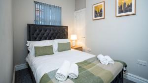 a bedroom with a large bed with towels on it at Modern 2 BDR apartment at Queens by Belfast City Breaks in Belfast