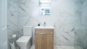 a white bathroom with a sink and a toilet at Modern 2 BDR apartment at Queens by Belfast City Breaks in Belfast