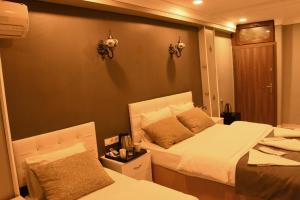 Postel nebo postele na pokoji v ubytování Californiacityhotel