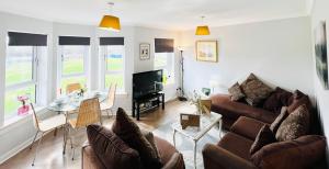 a living room with a couch and a table at Luxurious & Modern Apartment in Hawkhead