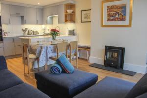 a living room with a kitchen and a dining room at 13 Combehaven in Salcombe