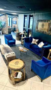 a living room with blue couches and chairs at Hotel Lex - Hotel and Conference Center in Lexington