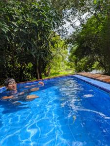 a man swimming in a blue swimming pool at Wild Wadi Wilpattu in Wilpattu