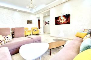 a living room with a couch and a table at Taj nouaceur aéroport Mohamed V in Nouaseur