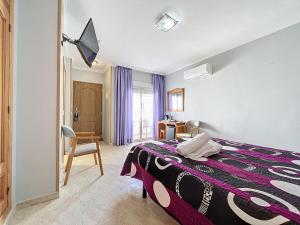 a bedroom with a bed with a purple blanket at Hotel Noguera El Albir in Albir +37 photos