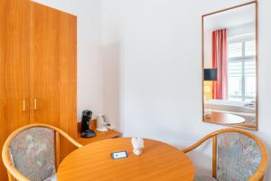 um quarto com uma mesa de madeira e um espelho em Pension Wald und See em Ahlbeck