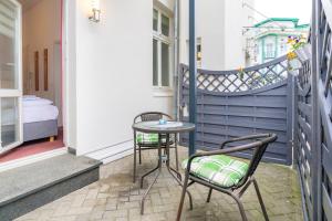 een kleine tafel en 2 stoelen op een balkon bij Pension Wald und See in Ahlbeck