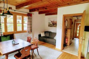 a living room with a table and a couch at Wald & Bach Gutenstein (50 Minuten von Wien) in Gutenstein