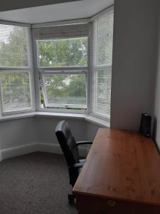a conference room with a wooden table and two windows at Portsmouth House near Center 3 Bedrooms in Portsmouth