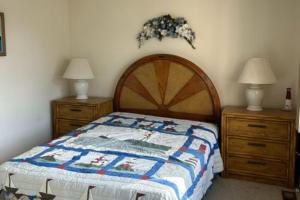 a bedroom with a bed and two dressers and two lamps at Sea Breeze Beach View in Seaside Heights