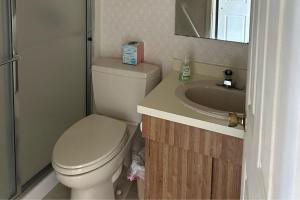 a bathroom with a toilet and a sink at Sea Breeze Beach View in Seaside Heights