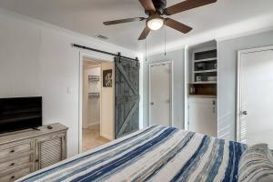 a bedroom with a bed and a ceiling fan at Blue Moon (Mustang Isle #11) in Port Aransas