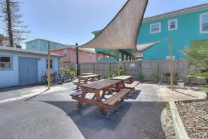 a group of picnic tables in front of a building at Blue Moon (Mustang Isle #11) in Port Aransas
