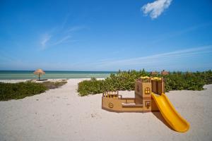 a toy train on a beach with a slide at SIELA Oceanfront Luxury 4 BR Villa in San Bruno