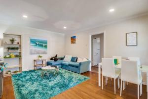 a living room with a blue couch and a table at Entire Private Cozy 3-Bedroom House, 10 mins San Diego Gaslamp in National City