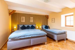 2 camas en un dormitorio con paredes amarillas en Apartmán v centru en Česká Lípa