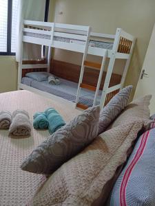 two bunk beds in a room with pillows on a bed at Apartamento BEIRA MAR in Fortaleza