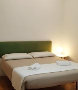 a bed with two white towels on top of it at Flaminia71 in Rome