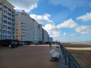 a building on a beach next to a building at Appartement 'East' kortbij de zee in Ostend