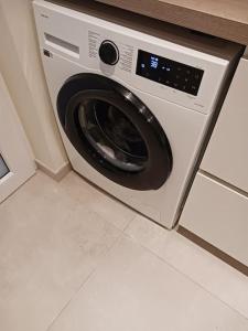 a washing machine sitting in a kitchen at Appartement 'East' kortbij de zee in Ostend