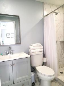 a bathroom with a toilet and a sink and a shower at Studio University Pines at Sarasota in Sarasota