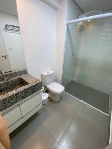uma casa de banho com um WC e uma cabina de duche em vidro. em Flat Diamond 908 em São Lourenço