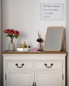 a white dresser with a mirror on top of it at CENTER BOUTIQUE HOME SUL FIUME in Ascoli Piceno