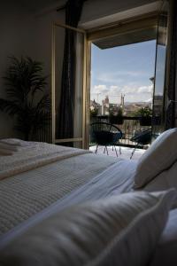 a bedroom with a bed and a view of a balcony at CENTER BOUTIQUE HOME SUL FIUME in Ascoli Piceno