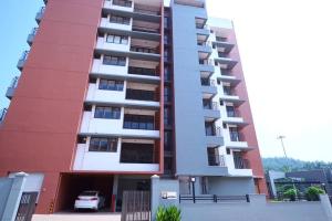 a tall apartment building with a car parked outside at The Nova Heights in Kozhikode