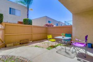 a patio with chairs and a table and a fence at Entire Private Spacious 3-Bedroom Home w Parking & Pool, Prime Location in La Mesa