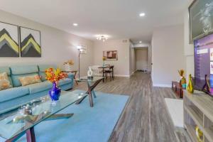 a living room with a blue couch and a table at Entire Private Spacious 3-Bedroom Home w Parking & Pool, Prime Location in La Mesa