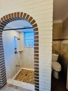 uma casa de banho com um chuveiro e um WC. em Deerfield Beach Retreat em Deerfield Beach
