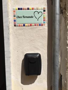 a black soap dispenser on the side of a wall at Chez Fernando front beach in Lerici