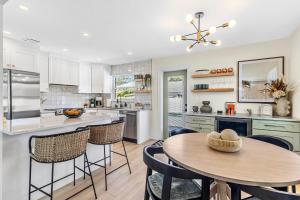 a kitchen with a table and chairs and a counter at Madeira Beach House Retreat with Private Pool - The Perfect Getaway! in St Pete Beach