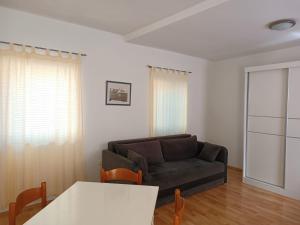 a living room with a couch and a table at Apartment Udovičić Center in Vodice