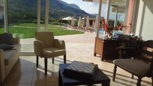 a living room with a view of a pool at Kalloni Royal Resort in Kalloni