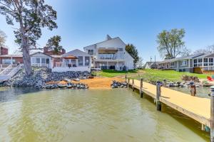a waterfront home with a dock and houses at Waterfront Colonial Beach Studio with Boat Dock! in Colonial Beach