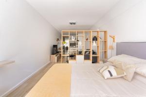 a bedroom with a large white bed and a shelf at Charming apart in Palermo in Buenos Aires