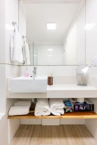 a white bathroom with a sink and a mirror at Charming apart in Palermo in Buenos Aires