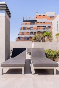 a pair of benches sitting on top of a building at Charming apart in Palermo in Buenos Aires