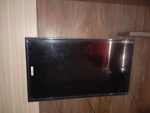 a flat screen tv hanging on a wall at Balqees Cottage in Lahore
