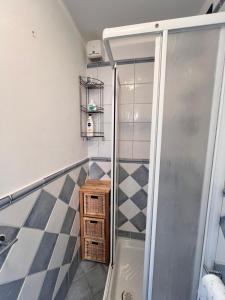 a shower in a bathroom with a tiled floor at CASA ELENA in Sanremo